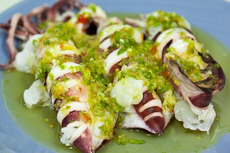 Steamed squid, topped with chiliの写真素材