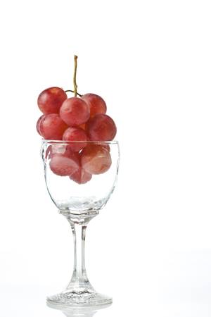 red Grape in the glass isolated on white backgroundの写真素材