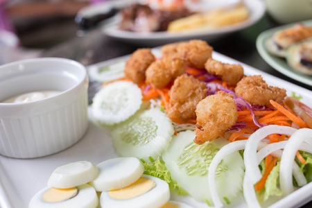 Salad with fried shrimp and creamの写真素材