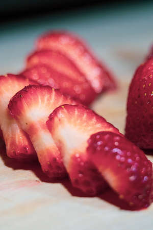 Fresh Sliced Strawberry on Cutting Boardの写真素材