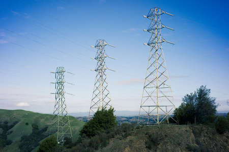 Blue Sky and Power Lines on a Hillの写真素材