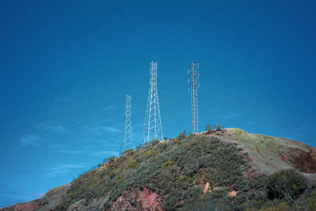 Blue Sky and Power Lines on a Hill