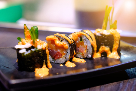 Salmon sushi roll with soft orange lightの写真素材
