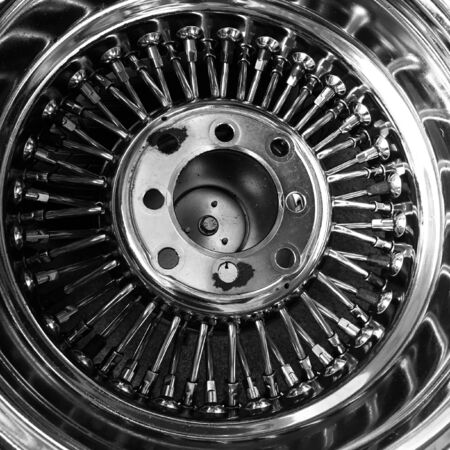 Part of rusty chrome retro wire spoke mag wheel (back view), black and white effectの写真素材