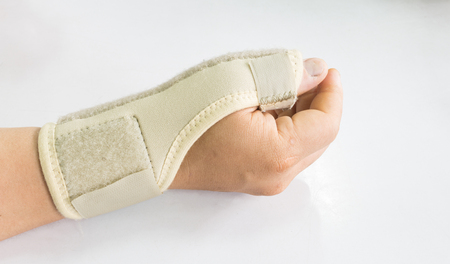 Elastic wrist support brace band wrap on hand to relieve pain, selective focusの写真素材