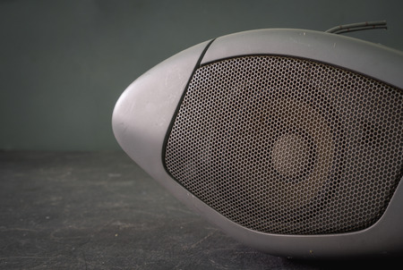 Part of old car audio speaker grill with selective focus and vintage filtered effectの写真素材