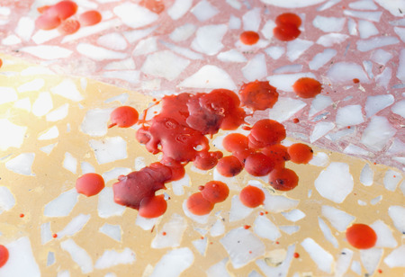 Many of red candles dripping drops on terrazzo floor with selective focusの写真素材