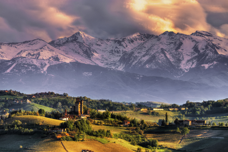 The castle of Serralunga d'Alba, with the background of the Alps, at sunset. We are in the Langhe, Cuneo province, Piedmont, North Italy. UNESCO World Heritage Site.のeditorial素材