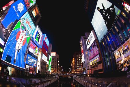 OSAKA - NOVEMBER 28:Bright neon signs light up Dombotori canal in the Osaka entertainment. Existing since 1935, Glico Man is one of most recognized neons worldwide. Nov 28, 2012 in Osaka Japanのeditorial素材