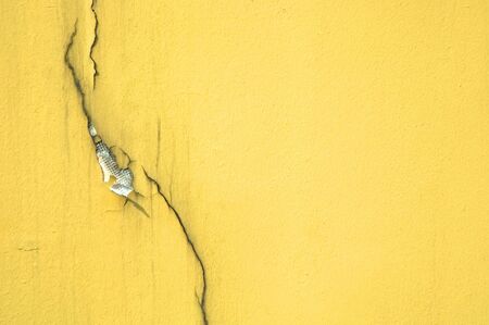 Crack on yellow textured wallの写真素材