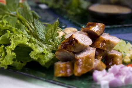 Asian Sausages served with vegetables and onionsの写真素材