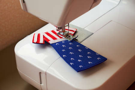 The process of sewing felt toy dress with American flag. National clothes. Gifts for US Independence Day. American day.の写真素材