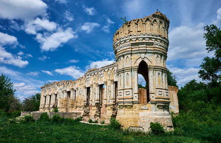 Old dilapidated castle on a background of blue sky with clouds. Brick walls. No windows.のeditorial素材