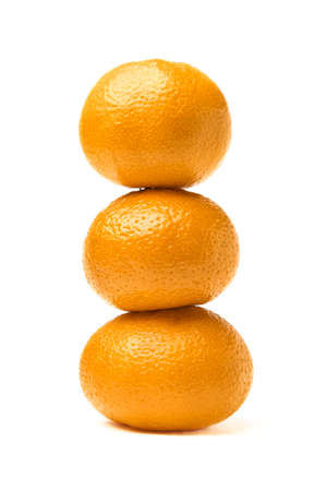 Tangerine snowman. Three tangerines lined up on top of each other in the shape of a snowman.の写真素材
