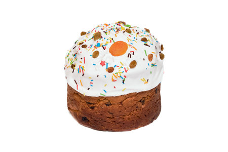 Christmas cake, sprinkled with icing and decorated with dried apricots, raisins and colored topping. Panettone isolated on white background.の写真素材