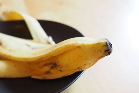 banana skin close up on a black plate.の写真素材