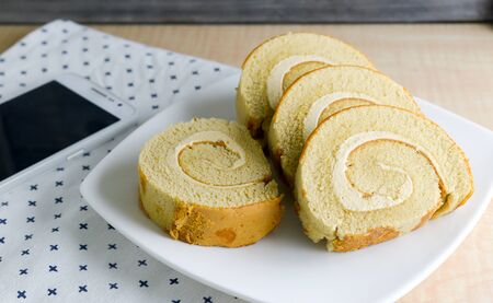 Coffee flavored roll cake on a plateの写真素材