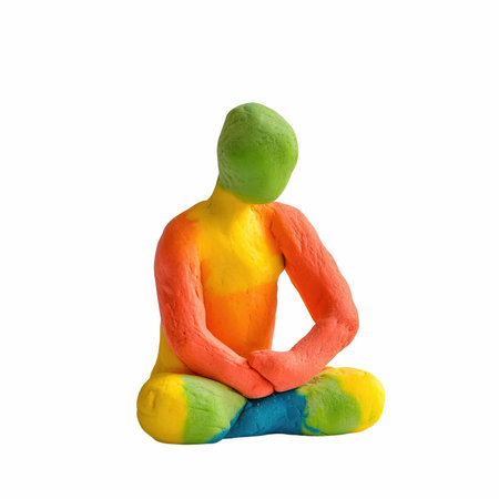 Plasticine clay man sitting in lotus position isolated on white backgroundの写真素材