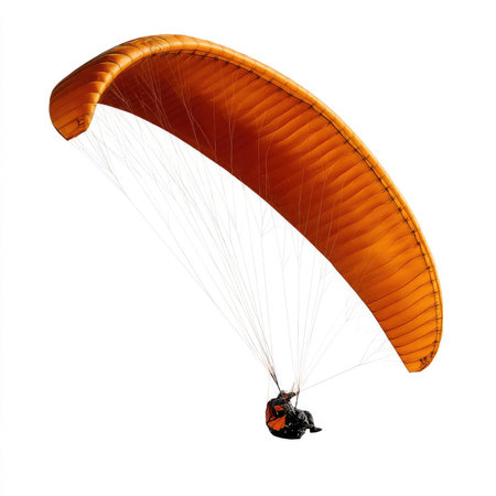A vivid orange paraglider in flight against a crisp white background, perfect for capturing the essence of adventure and thrill in sports.の写真素材