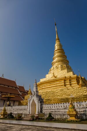 Golden Pagoda with Blue Sky, Wat Phra That Chae Hang - Nan, Thailandの写真素材
