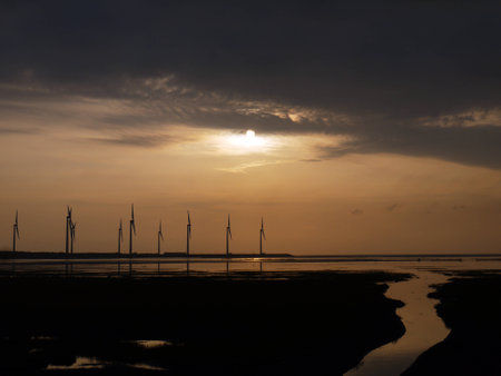 Sunset view at wind turbine farmの写真素材