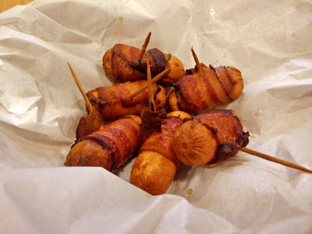 Grilled sausages wrapped in baconの写真素材
