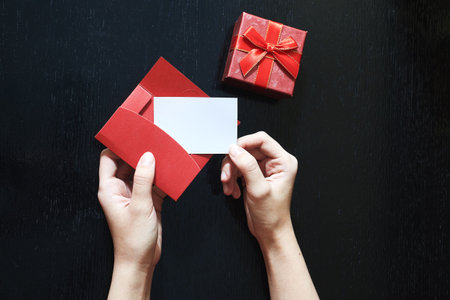 A girl writing a Love message. Closeup image of woman writing a letter with copy space. A gift box...