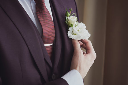 Close up of female hands ties the lacing of wedding dress. Preparation of the bride.の写真素材