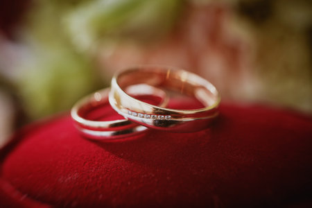 Close up of female hands ties the lacing of wedding dress. Preparation of the bride.の写真素材