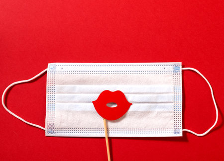 Six white paper sheets pinned with clothespin decorated with wooden hearts. Red background, copy space.の写真素材