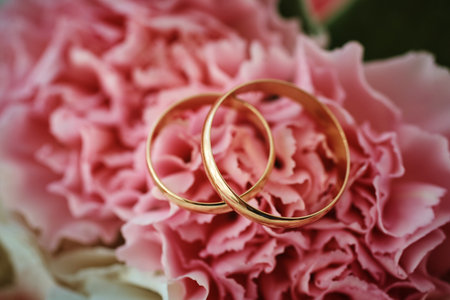 gold rings and a beautiful bridal bouquet of roses on the background. details, wedding traditions. close-up, macroの写真素材