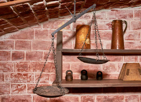 an antique washstand hanging on a chain over a copper basin.