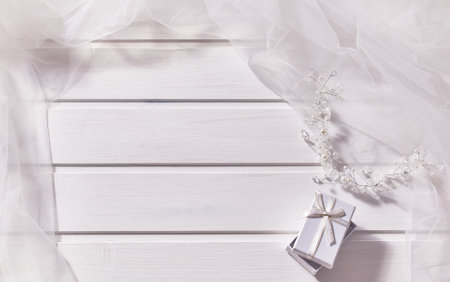 Jewelry made of beads, gift box, veil on a white wooden background. Copy space, top viewの写真素材