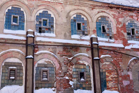 An abandoned, crumbling old factory building. Winter landscape.の写真素材