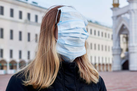 A young girl in black clothes holds a photo lens with an inverted image - her face. Close-up.