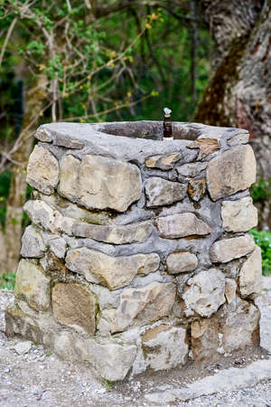 Ancient stone drinking fountain with mineral water. Close-upの写真素材