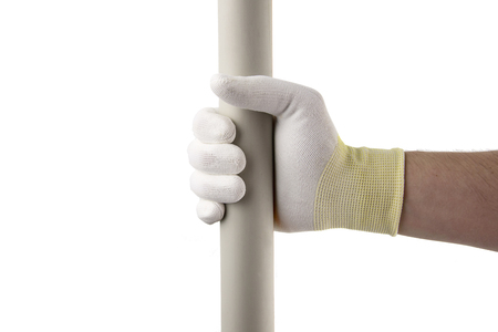 Vertical plastic pipe in the hand in white glowe on white background isolated. Suitable for any purprose use. Suitable for any purprose use.の写真素材
