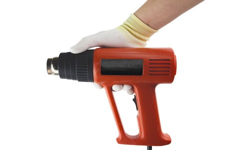 Heat gun in the hand iglowe on the white background isolatedの写真素材