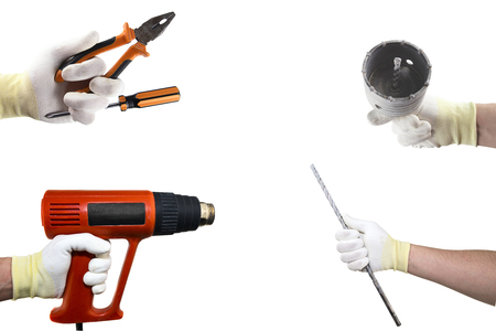 Different construction tools in the hand. Isolated on white backgroundの写真素材