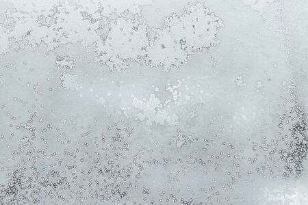 Frosty pattern on the frosed window. Texture of the ice on the glass. Winter background close-up.の写真素材