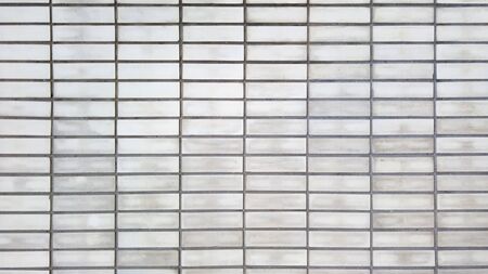 Old grey brick wall closeup background textureの写真素材