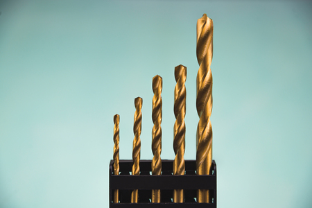 Yellow drills in black case on blue background isolated. Suitable for any purprose use.の写真素材
