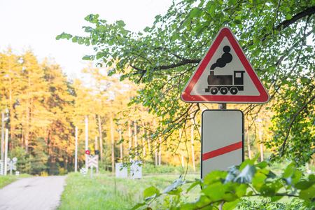 Railroad sign in the forest with semaphore on the backgroundの写真素材