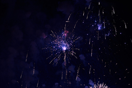 Inexpensive fireworks, over the city, red and blue . For any purposeの写真素材