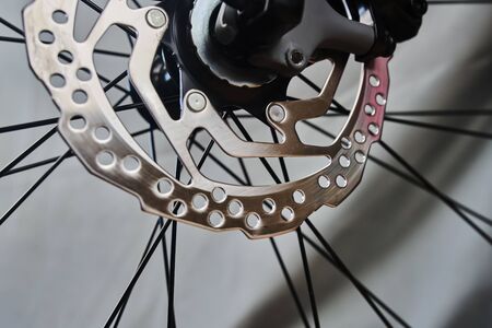 Front disc brake rotor of the sport bike close up on the grey backgroundの写真素材
