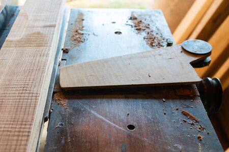 Working woodworking machine with secure covered plane close up. Selective focus. Manual wood processing concept.の写真素材