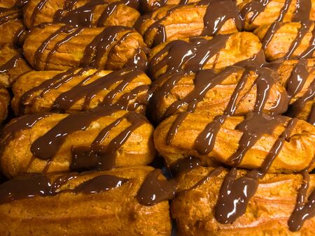 Cream puffs with chocolate closeup