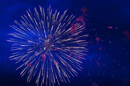 Inexpensive fireworks, over the city, red and blue. Celebration conept, Motion blur, For any purposeの写真素材