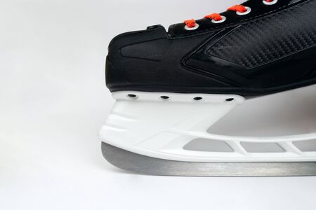 Hockey skates front with blade closeup isolated on grey background. Selective focus.