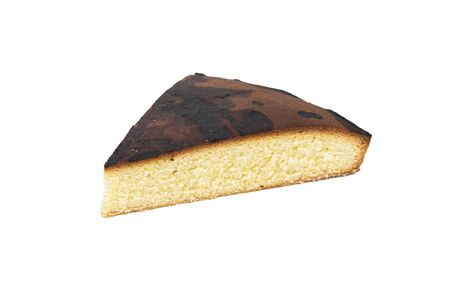 A piece of homemade baked biscuit cake isolated on white. High quality photoの写真素材